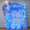 Party Lighting And Pastel Balloon Clusters Frame A Blue Fringe Backdrop With A Curved Shape.