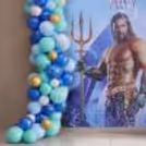 Chrome Golden Number Foil Balloon On Superhero Background For Milestone Birthday Celebration.