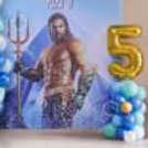 Pastel Blue And Metallic Blue, White, Green And Golden Colored Balloons In Combination With A Personalised Flexi Board.