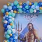 Big And Small Blue, Aqua, White, And Golden Balloons With A Customised Aquaman Poster.
