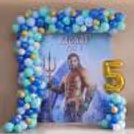 Aquaman Character Background With Colored Balloon Garland And Personalised Birthday Display.