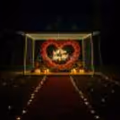 Luxury proposal setup featuring a grand red roses heart décor, candlelight dinner, and romantic ambience for an unforgettable marriage proposal.
