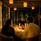 Elegant "Will You Marry Me" proposal setup with a giant red roses heart backdrop, candlelit dinner, and intimate luxury décor for couples.