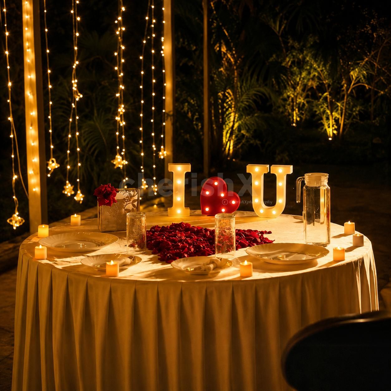 Romantic heart-shaped red roses proposal decoration with elegant candlelight dining and premium floral décor for couples.