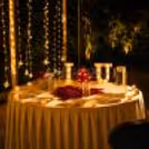 Romantic heart-shaped red roses proposal decoration with elegant candlelight dining and premium floral décor for couples.