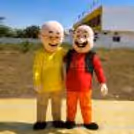 Motu and Patlu are two live characters who can be seen standing together outdoors, ready to entertain children at a birthday party.