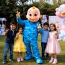 At a kid’s birthday party, the live Cocomelon characters greet them with a fun and friendly look.