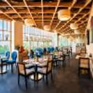 Contemporary hotel apartment with wooden interiors, dining space, kitchenette, and premium guest amenities.