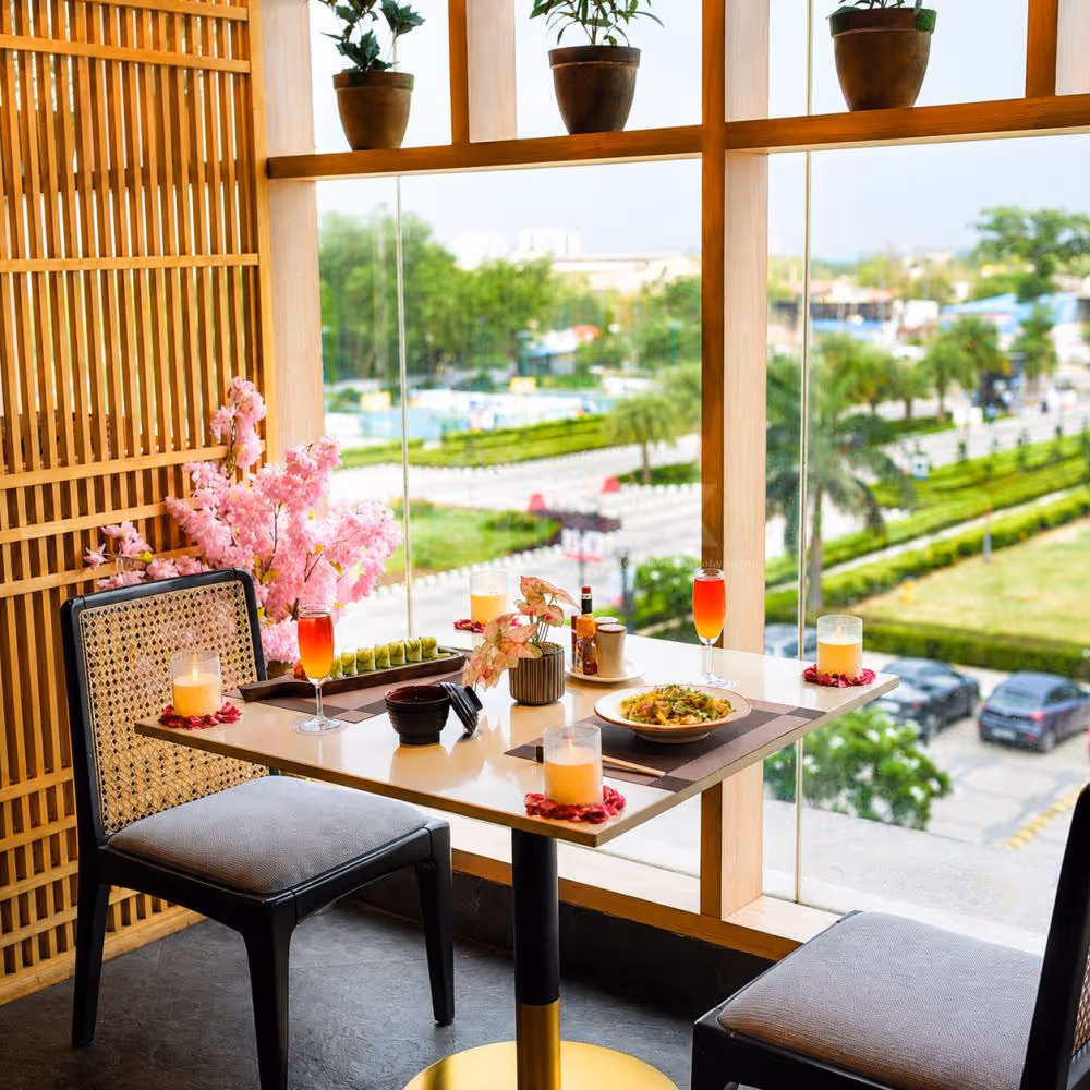 Premium indoor romantic dining experience with gourmet food, colorful mocktails, candles, and panoramic garden views.