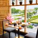 Premium indoor romantic dining experience with gourmet food, colorful mocktails, candles, and panoramic garden views.