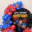 Close-up of round flex with child's name, birthday message and comic book-style superhero artwork.