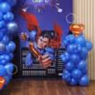 Close-up of personalised birthday flex with the name of the child and images of a superhero.