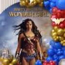 The Wonder Girl backdrop in close-up, with the printed personalised artwork, chrome golden balloons, and decorative elements of the superhero.