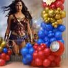 Transparent bubble balloons in red, dark blue and golden clusters around a themed display.