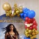 Bottom of the party setup with superhero cutouts, balloon bouquets piled up, and balloon ring stand details.
