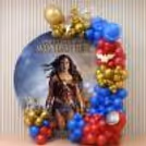 Superhero theme decoration, Wonder Woman birthday ring backdrop, custom circular flex, colourful balloon decor.