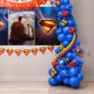 Side angle view of colourful balloons, multiple blue balloon designs, character cutouts and clear bubble balloons.