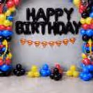 A nice order of oversized foil lettering, superhero paper bunting and colourful balloon bunches on the central display.