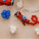 Red airplane balloon close-up on birthday wall with white cloud balloons and blue polka dot balloon flowers.