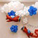 Side view of a birthday arrangement with layered balloon decorations for a playful flying adventure.
