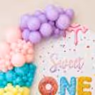 Colourful Arch With A Donut And A Sweet-Themed Party Decor.