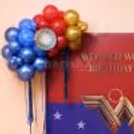 Personalised Wonder Woman birthday backdrop with superhero artwork and balloon on both sides.