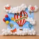 Sky-inspired party display with fluffy white cloud balloons, airplane foil balloon and colourful celebration wall.