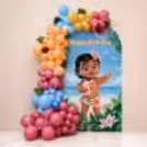 Customised tropical-theme flex with pastel balloon design, floral accent and decorative monstera leaves for a backdrop.