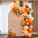 Baby shower panel backdrop with pastel balloon design and citrus-themed decor.