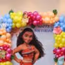 Magenta, yellow, peach and blue balloons with leafy accents and tropical character details in the upper arrangement.