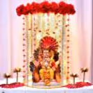 Red flowers were decorated on the Ganesh idol with hanging garlands, fairy lights and lotus lamps.