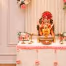 Floral Ganpati decoration with hanging pearl strings and pink flowers