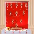 Red velvet curtain with golden lace, pearl tassels and small hanging bells.
