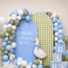 Cute baby shower welcome decoration with blue and green balloons, duck cutouts, baby blocks.
