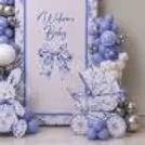 Sweet welcome with cute bunny prop near a decorative baby crib.