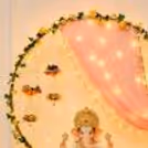 The LED candles in brass lotus holders around the Ganpati pillar enhance the traditional and festive mood.