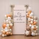 A baby backdrop welcomes home with a teddy bear and warm beige balloon.