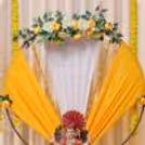 Floral cluster of yellow and white flowers with green leaves placed on the top of the decorated background.