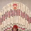 Circular Ganpati decoration with flying floral strings, lotus-themed ornaments, and decorative lotus symbols placed on top.