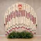 Floral garlands with lotus ring decoration, warm lighting and a beautifully styled backdrop for a Ganpati celebration.