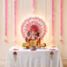 Artificial pink and white round rose decoration background with warm LED lights and hanging pink flower garlands for diy.