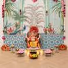 Artificial pink garlands, MDF lotus decorations, peacock theme Ganpati backdrop and peacock decorative artwork; premium peacock theme Ganpati backdrop is available.