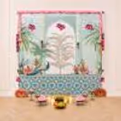 Traditional Ganpati decoration with wall backdrop designed in peacock design, lotus tassels hanging, pearl hangings, and beautiful floral decoration.