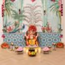 Ganpati pooja backdrop with peacock theme flex with floral lotus hangings, pearl tassels, and top-quality festive wall decoration.