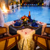 Private poolside cabana dining experience for couples at Grand Mercure Bangalore during the evening.