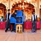 Live grand stage illusion performance featuring a magician, assistant, and large illusion equipment during a magic show.