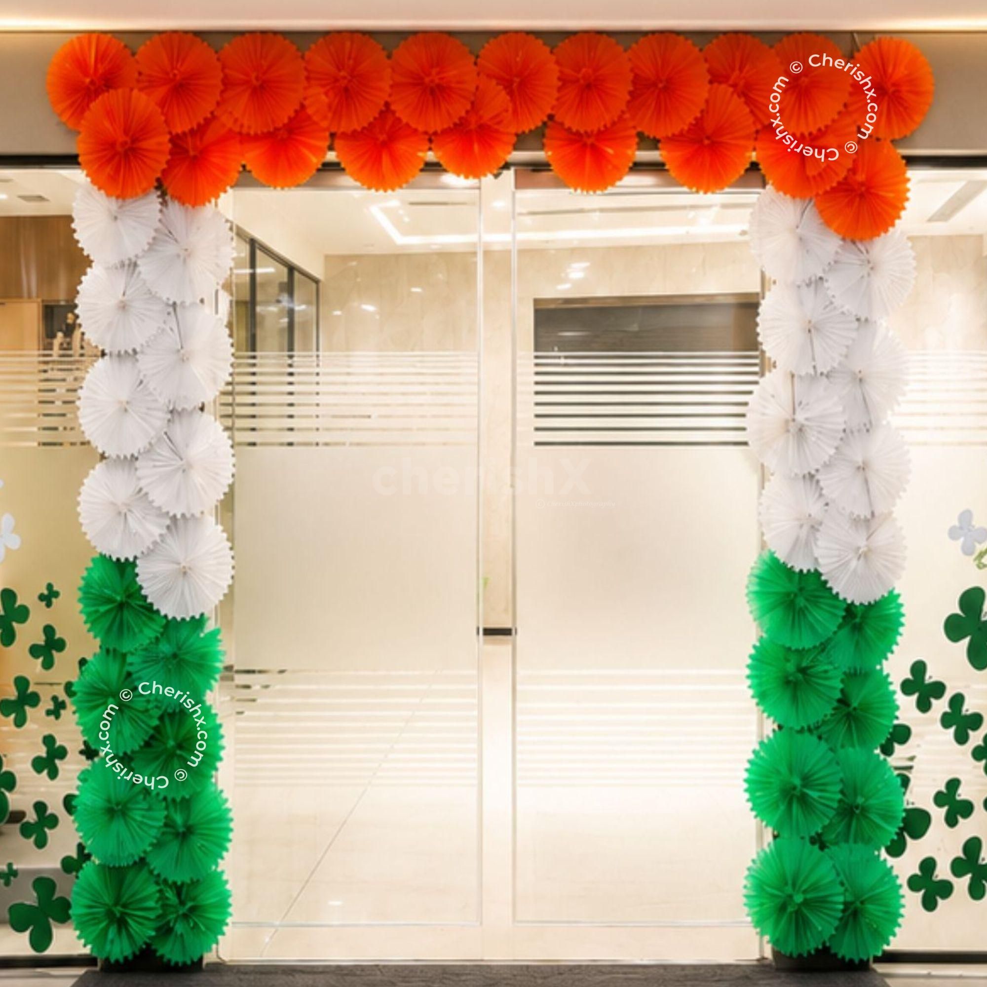 Tricolour Paper Rosettes Entrance Wall Decor for Patriotic Celebrations with Layered Orange, White and Green Paper Fans.