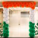 Tricolour Paper Rosettes Entrance Wall Decor for Patriotic Celebrations with Layered Orange, White and Green Paper Fans.