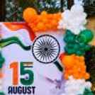 Customised 15 August banner for Independence Day event backdrop, tricolour balloon arch and macron balloons for photo opportunities.