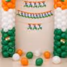 Paper bunting for Independence Day event with tricolour balloon backdrop and Indian flag accents